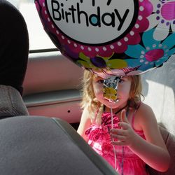 Girl holding birthday balloon