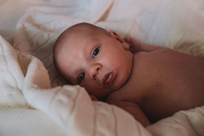 Close-up of cute baby sleeping on bed at home