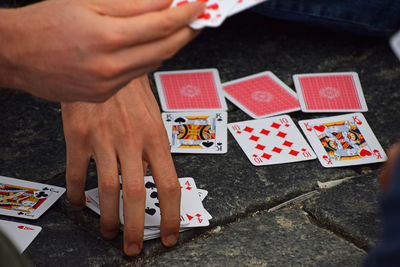 High angle view of hands playing on table