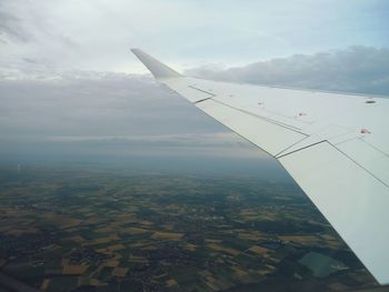 Cropped image of airplane flying over landscape