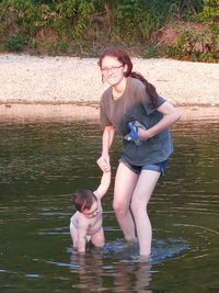 Full length of mother and woman in lake