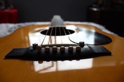 Close-up of guitar on table at home