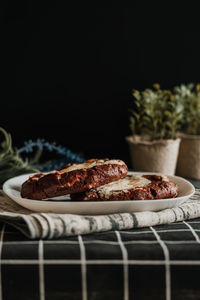 Close-up of red velvet cookie on table against black background