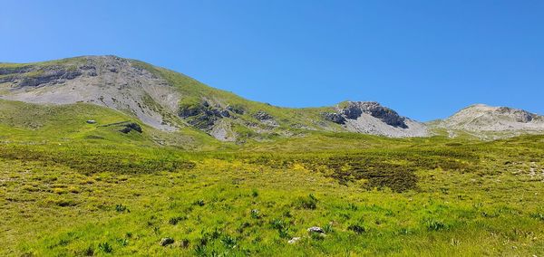 Scenic view of mountains against clear blue sky