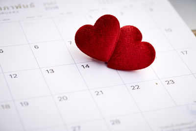 Close-up of red heart shapes on calendar