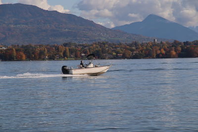 Scenic view of sea and mountains against sky