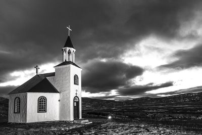 Church by sea against sky