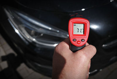 Cropped hand of person holding car