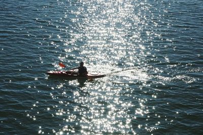 Person kayaking in sea