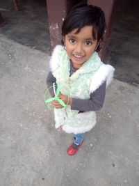 Portrait of smiling girl standing outdoors