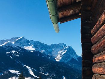 Scenic view of snowcapped mountains against clear blue sky