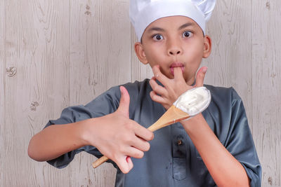 Portrait of boy preparing food in kitchen