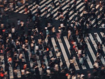 Blur image of people walking on zebra crossing
