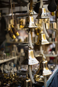 Close-up of bells hanging for sale at market