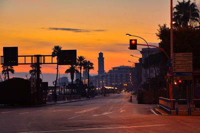 Cars on road at sunset