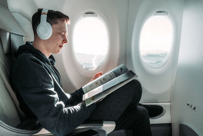 Side view of man sitting in bus