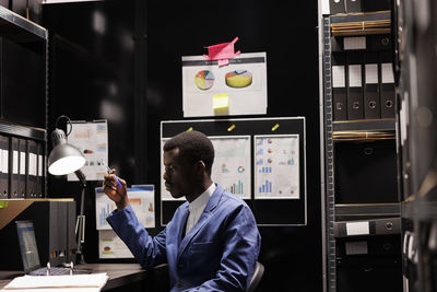 Rear view of man working in office