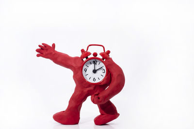 Close-up of red clock against white background