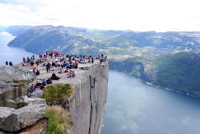 People on mountain against sky