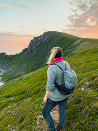 Rear view of woman looking at mountain against sky