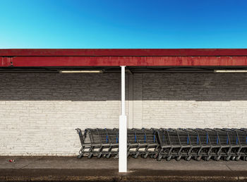 Empty shopping carts lined up waiting for shopping customers on a sunny sunday morning.