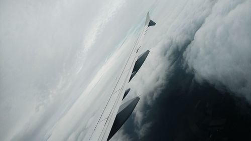 Low angle view of airplane flying in sky