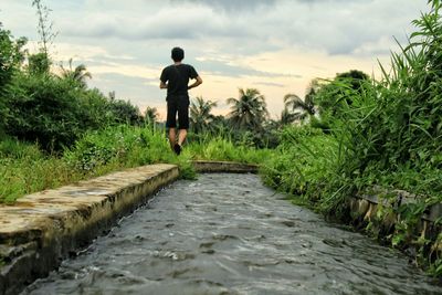 Full length of man walking in water