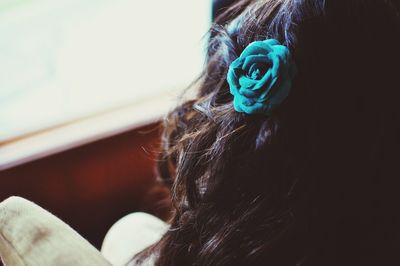 Close-up of woman wearing flower at home