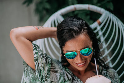 Portrait of young woman wearing sunglasses