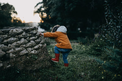 Rear view of boy standing on land