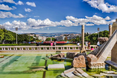 View of swimming pool by buildings in city