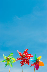 Close-up of colorful pinwheel toys against sky