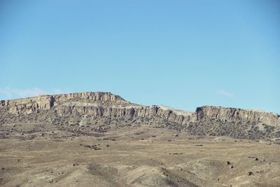 Scenic view of rocky mountains against clear blue sky