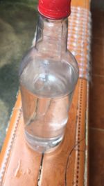 Close-up of empty glass bottle on table