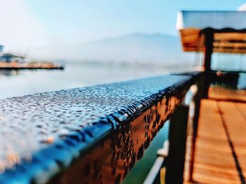 Close-up of pier over sea against sky