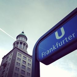 Low angle view of information sign against blue sky