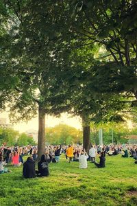 Group of people relaxing on field