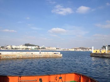 Scenic view of sea by city against sky