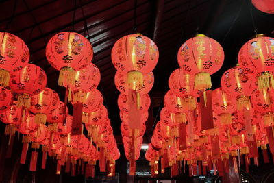 Low angle view of illuminated chinese lanterns hanging from ceiling