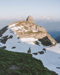 Scenic view of mountain and sea against sky