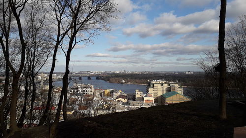 High angle view of townscape by sea against sky