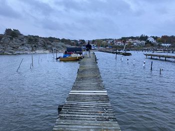 Pier over lake against sky