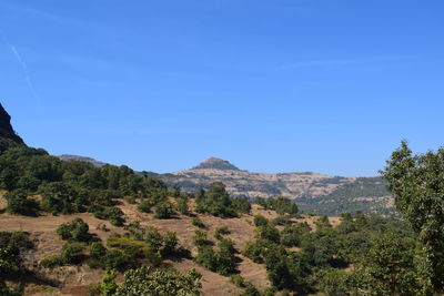 Scenic view of mountains against clear blue sky