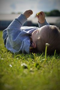 Close-up of boy lying on grass