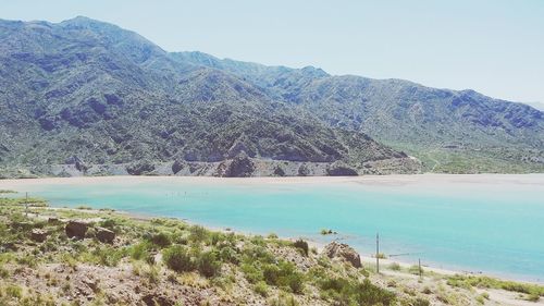 Scenic view of lake and mountains against clear sky