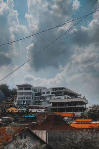 Low angle view of houses and buildings against sky