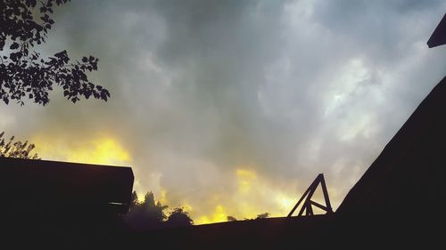 Low angle view of silhouette trees against sky during sunset