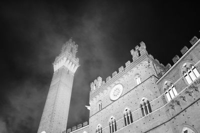 Low angle view of illuminated building against sky at night