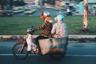 Rear view of women on motorcycle