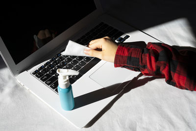 High angle view of person using laptop on table